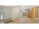 Bright entryway with tile floors, staircase, and wine rack at 875 Indian Beach Dr, Sarasota, FL 34234