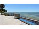Peaceful waterfront view with a blue bench at 875 Indian Beach Dr, Sarasota, FL 34234
