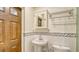 Simple bathroom with pedestal sink and tiled walls at 875 Indian Beach Dr, Sarasota, FL 34234