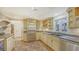 Kitchen with stainless steel appliances and light wood cabinets at 875 Indian Beach Dr, Sarasota, FL 34234