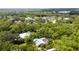 Aerial view showing home, pool, and lush landscaping in a wooded neighborhood at 9219 59Th E Ave, Bradenton, FL 34202