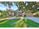 House exterior showcasing stone accents, lush landscaping, and a welcoming front entrance at 3727 59Th Avenue E Cir, Ellenton, FL 34222