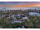 Aerial view of a coastal home, showcasing a private beachfront property at sunset at 7665 Sanderling Rd, Sarasota, FL 34242