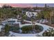 A beautiful aerial view of a modern home with a pool and extensive landscaping at 7665 Sanderling Rd, Sarasota, FL 34242