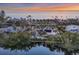 An aerial view of a luxury home, beautifully integrated into a lush beachfront at 7665 Sanderling Rd, Sarasota, FL 34242