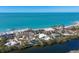 Ariel view of an opulent property, highlighting the meticulously designed landscaping and beachfront access at 7665 Sanderling Rd, Sarasota, FL 34242