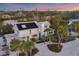 Stylish home with solar panels and coastal charm, nestled amongst palm trees and lush greenery near the water at 7665 Sanderling Rd, Sarasota, FL 34242