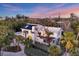 Charming home with solar panels amidst lush greenery and palm trees, capturing a blend of comfort and sustainability at 7665 Sanderling Rd, Sarasota, FL 34242