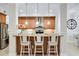 Kitchen boasts a breakfast bar with three stools and wood cabinets at 7922 Tybee Ct, University Park, FL 34201
