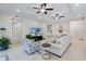 Spacious living room with sectional sofa, large TV, and ceiling fans at 7922 Tybee Ct, University Park, FL 34201