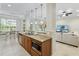 Open kitchen with granite countertops, island, and view into living room at 7922 Tybee Ct, University Park, FL 34201