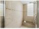 Walk-in shower with tiled walls and a built-in seat at 7922 Tybee Ct, University Park, FL 34201