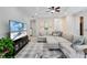 Open living area with sectional sofa, large TV, and access to patio at 7922 Tybee Ct, University Park, FL 34201