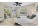 Spacious bedroom with a large bed, access to a patio, and a ceiling fan at 7922 Tybee Ct, University Park, FL 34201