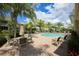 Community pool with ample deck space and lounge chairs at 7922 Tybee Ct, University Park, FL 34201