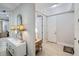 Elegant entryway with tiled floors, white console table, and charming lamps at 7922 Tybee Ct, University Park, FL 34201
