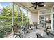 Relaxing screened porch with seating area and view of tropical landscape at 7922 Tybee Ct, University Park, FL 34201