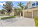 Tan two-story townhome with two-car garage and lush landscaping at 7922 Tybee Ct, University Park, FL 34201