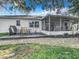 Home's backyard features a screened porch and patio at 2843 Abbotsford St, North Port, FL 34287