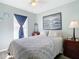 Bedroom with queen bed, window with blinds, and ocean-themed art at 2843 Abbotsford St, North Port, FL 34287