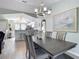 Bright dining room with kitchen view, large table, and chandelier at 2843 Abbotsford St, North Port, FL 34287