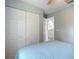 Bedroom with a queen bed, closet, and view of a small kitchen at 2843 Abbotsford St, North Port, FL 34287