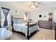 Main bedroom with a metal bed frame, dresser, and window curtains at 2843 Abbotsford St, North Port, FL 34287