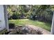 Landscaped backyard with lush greenery and a gravel pathway at 2843 Abbotsford St, North Port, FL 34287