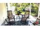 Screened porch with comfortable seating and a view of the garden at 2843 Abbotsford St, North Port, FL 34287