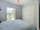 Bedroom with a queen bed, large closet, and window overlooking garden at 2843 Abbotsford St, North Port, FL 34287