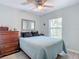 Bright bedroom with a queen bed, dresser, and large window at 2843 Abbotsford St, North Port, FL 34287