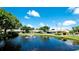 Scenic pond view with trees and community buildings at 2704 60Th Avenue S Plz # 2704, Bradenton, FL 34207