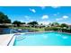 Inviting community pool area with lush landscaping at 2704 60Th Avenue S Plz # 2704, Bradenton, FL 34207