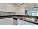 Modern kitchen with dark countertops and updated white cabinets at 2704 60Th Avenue S Plz # 2704, Bradenton, FL 34207