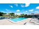 Community pool with lounge chairs and surrounding landscape at 2704 60Th Avenue S Plz # 2704, Bradenton, FL 34207