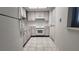 Galley kitchen with white cabinets and appliances at 6023 Hibiscus Dr # 177, Bradenton, FL 34207