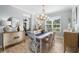 Bright dining room featuring a large chandelier and hardwood floors at 5828 Clairwood Ct, Palmetto, FL 34221