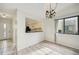 Dining room with laminate flooring, chandelier, and kitchen pass-through at 2708 60Th Avenue W Ter # A, Bradenton, FL 34207