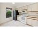 Bright kitchen features white appliances and granite countertops at 2708 60Th Avenue W Ter # A, Bradenton, FL 34207
