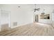 Large living area with laminate flooring and access to other rooms at 2708 60Th Avenue W Ter # A, Bradenton, FL 34207