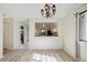 Bright dining area with laminate floors and kitchen view at 2708 60Th Avenue W Ter # A, Bradenton, FL 34207