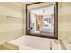 Bathroom with bathtub and window looking into bedroom at 915 Seaside Dr # 613 Weeks 28-29, Sarasota, FL 34242