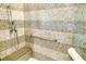 Walk-in shower with mosaic tile and built-in seat at 915 Seaside Dr # 613 Weeks 28-29, Sarasota, FL 34242