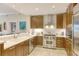 Modern kitchen with stainless steel appliances and wood cabinets at 915 Seaside Dr # 613 Weeks 28-29, Sarasota, FL 34242