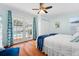 Bedroom with French doors leading to pool, complete with hardwood floors and coastal-themed curtains at 5307 2Nd Avenue Nw Dr, Bradenton, FL 34209