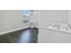 Bright bedroom with dark floors and a built-in shelf at 7889 Mainsail Ln, Sarasota, FL 34240