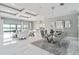 Elegant dining room with marble floors and modern chandelier at 7889 Mainsail Ln, Sarasota, FL 34240