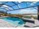 Inviting pool and spa with water features and lake view at 7889 Mainsail Ln, Sarasota, FL 34240