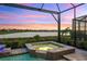 Private spa with water feature at sunset at 7889 Mainsail Ln, Sarasota, FL 34240