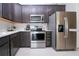 Modern kitchen with stainless steel appliances and dark wood cabinets at 11721 Brighton Knoll Loop, Riverview, FL 33579